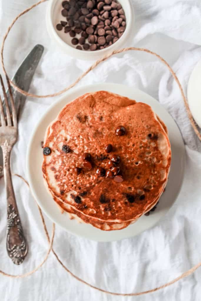 These healthy, vegan chocolate chip pancakes are made with whole wheat flour for maximum nutrition. They’re easy to make and incredibly delicious! #pancakes #vegan #veganbreakfast