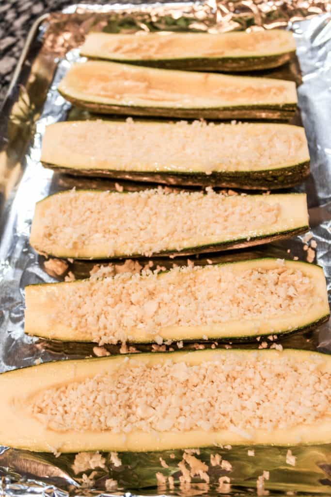Farm fresh zucchini packed with cauliflower rice and other goodies. It’s an easy, healthy baked side or appetizer recipe for a weeknight meal! #zucchini #vegan #vegetarian
