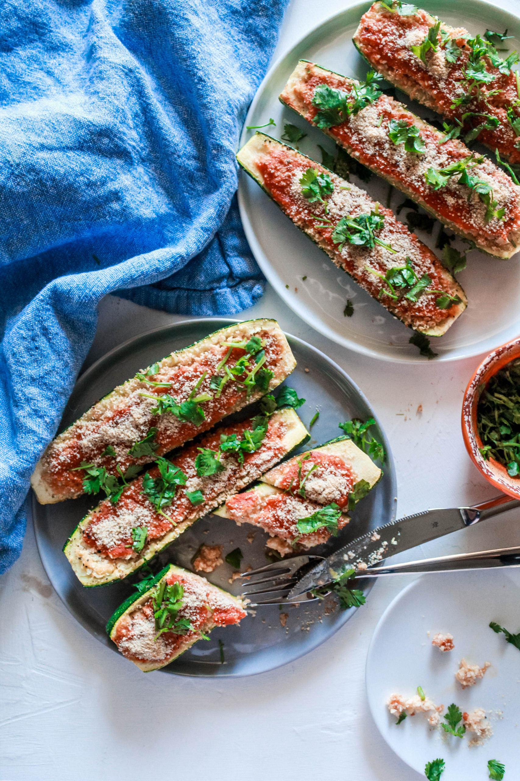 Farm fresh zucchini packed with cauliflower rice and other goodies. It’s an easy, healthy baked side or appetizer recipe for a weeknight meal! #zucchini #vegan #vegetarian