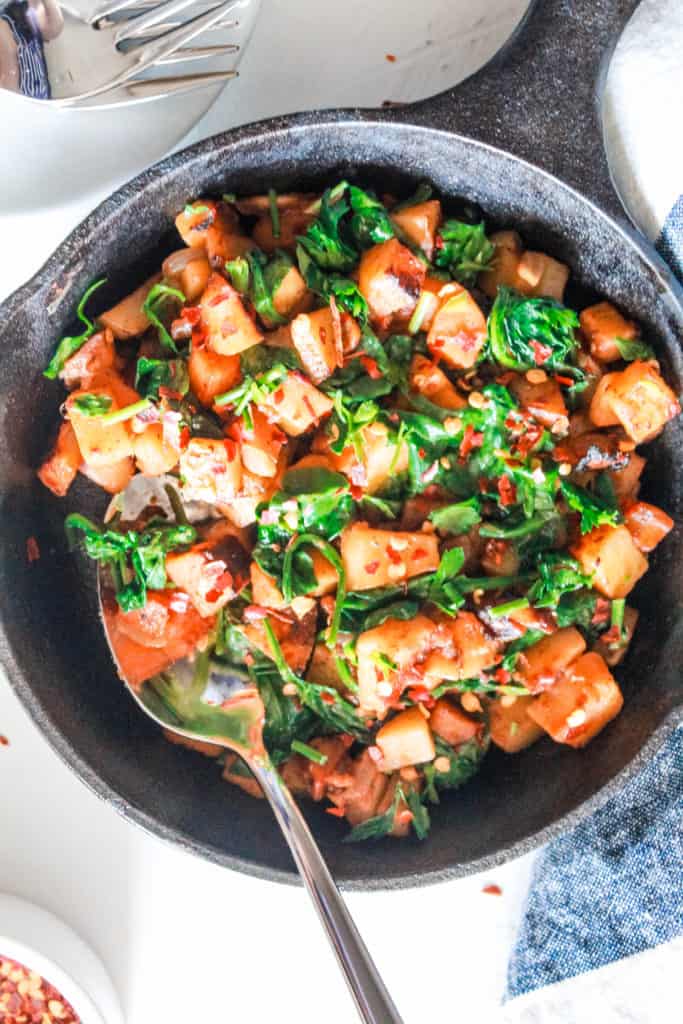 Fall in love with this satisfying, savory breakfast! This one-skillet breakfast hash is made with a mix of sweet and gold potatoes and spinach for a healthy kick! #veganbreakfast #hash #potatoes
