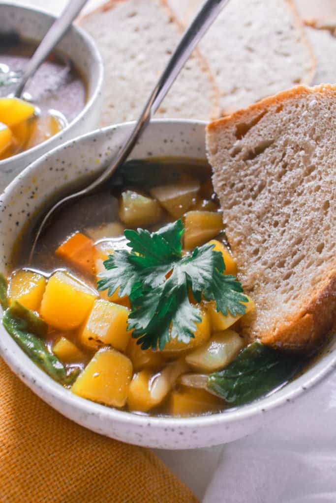 Warm up with this healthy, cozy, fall vegetable soup! It’s healthy, comforting soup loaded with freshly harvested autumn vegetables and spices. Plus, it’s ready under 30 minutes! #autumsoup #vegetablesoup #healthy #soup