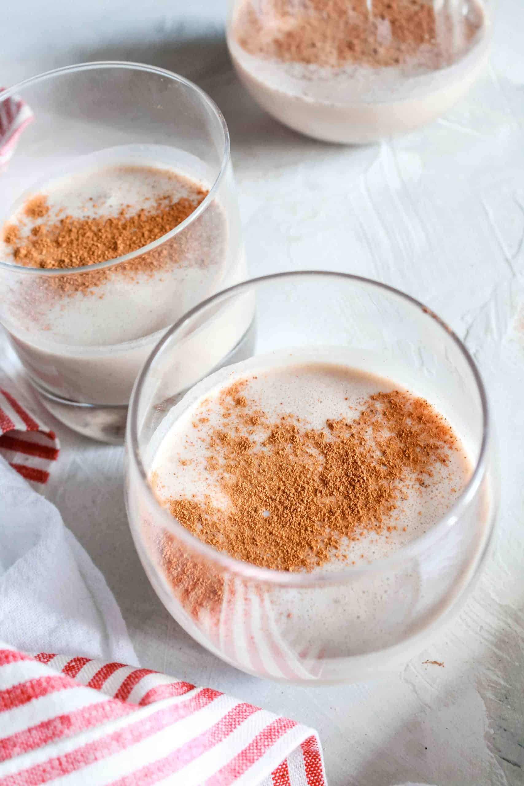 Easy, homemade, and comforting eggnog recipe that is made with natural sugar. It’s perfect for spiking for the holidays or a cold winter night! #eggnog #vegan #dairyfree