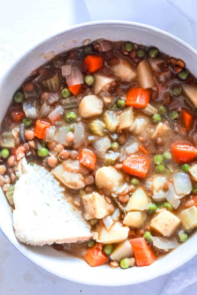 Rich, hearty, healthy stew made with vegetables and lentils. Perfect for dinner on a cold, chili night. Plus, it makes excellent leftovers! #stew #vegan #lentils
