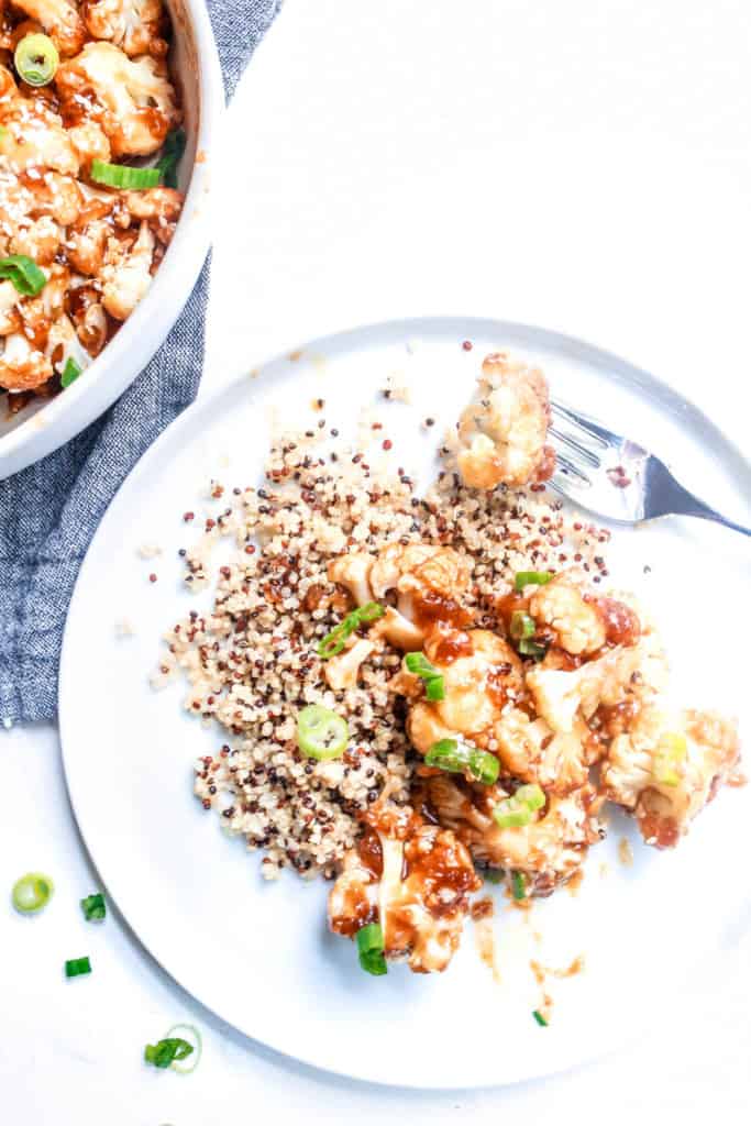 Try this healthy spin on a classic Chinese takeout. Baked cauliflower with delicious sticky-sweet Sesame sauce is an easy, go-to vegan meal! #sesame #cauliflower #vegan